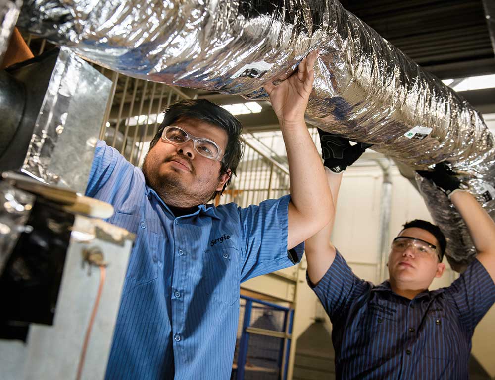 Air Conditioning students installing air duct