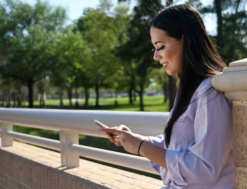 Student on phone outside